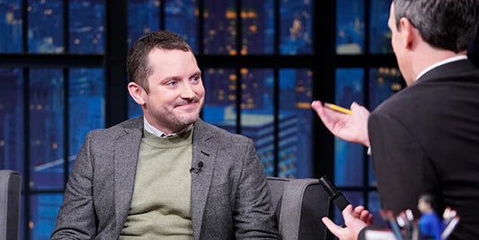 Elijah Wood wears a gray flannel suit from Brooklyn Tailors on Late Night with Seth Myers. 