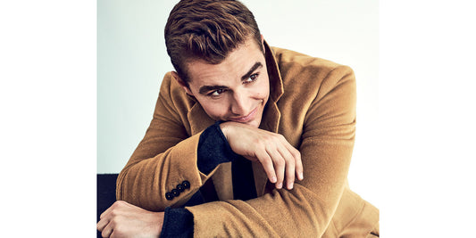 Dave Franco close-up wearing a tan Brooklyn Tailors overcoat over a black sweater