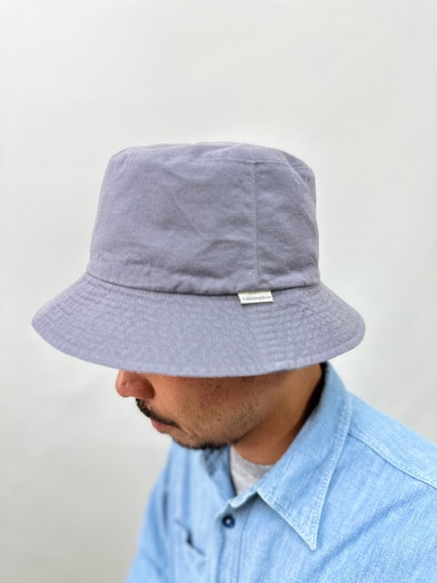 On-body shot of Cableami Reversible Cotton Bucket Hat (not in actual colors) to show fit.