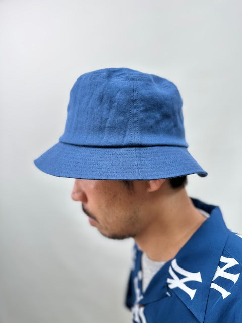 On-body shot to show how Cableami French Linen Bucket Hat fits.
