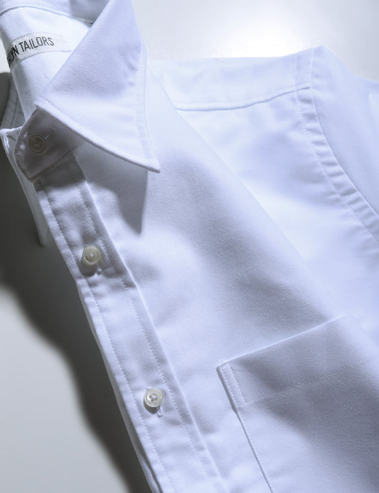 Detail of Brooklyn Tailors BKT14 Relaxed Shirt in Oxford - Bright White showing collar, placket, pocket, and fabric texture