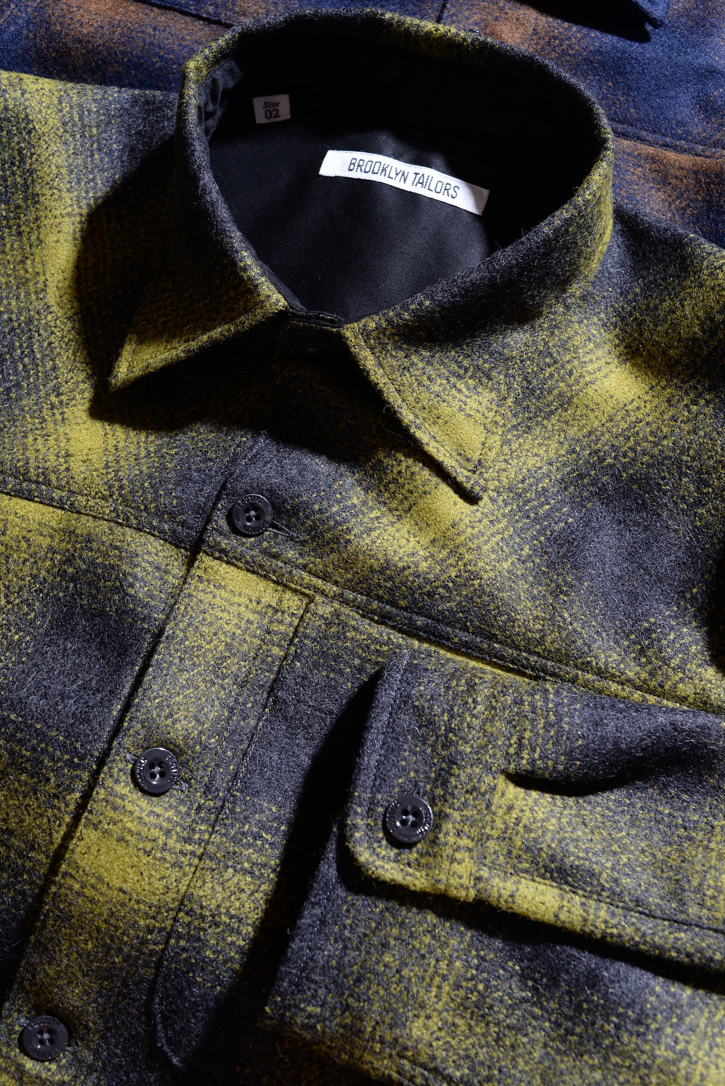 Close-up shot of collar and cuff of Brooklyn Tailors BKT15 Shirt Jacket in Boiled Wool Plaid - Gray & Acid Green