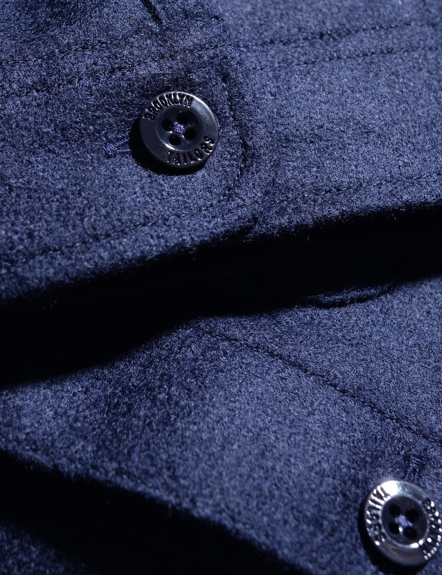 Close-up shot of BKT15 Shirt Jacket in Boiled Wool - Navy showing buttons and fabric texture