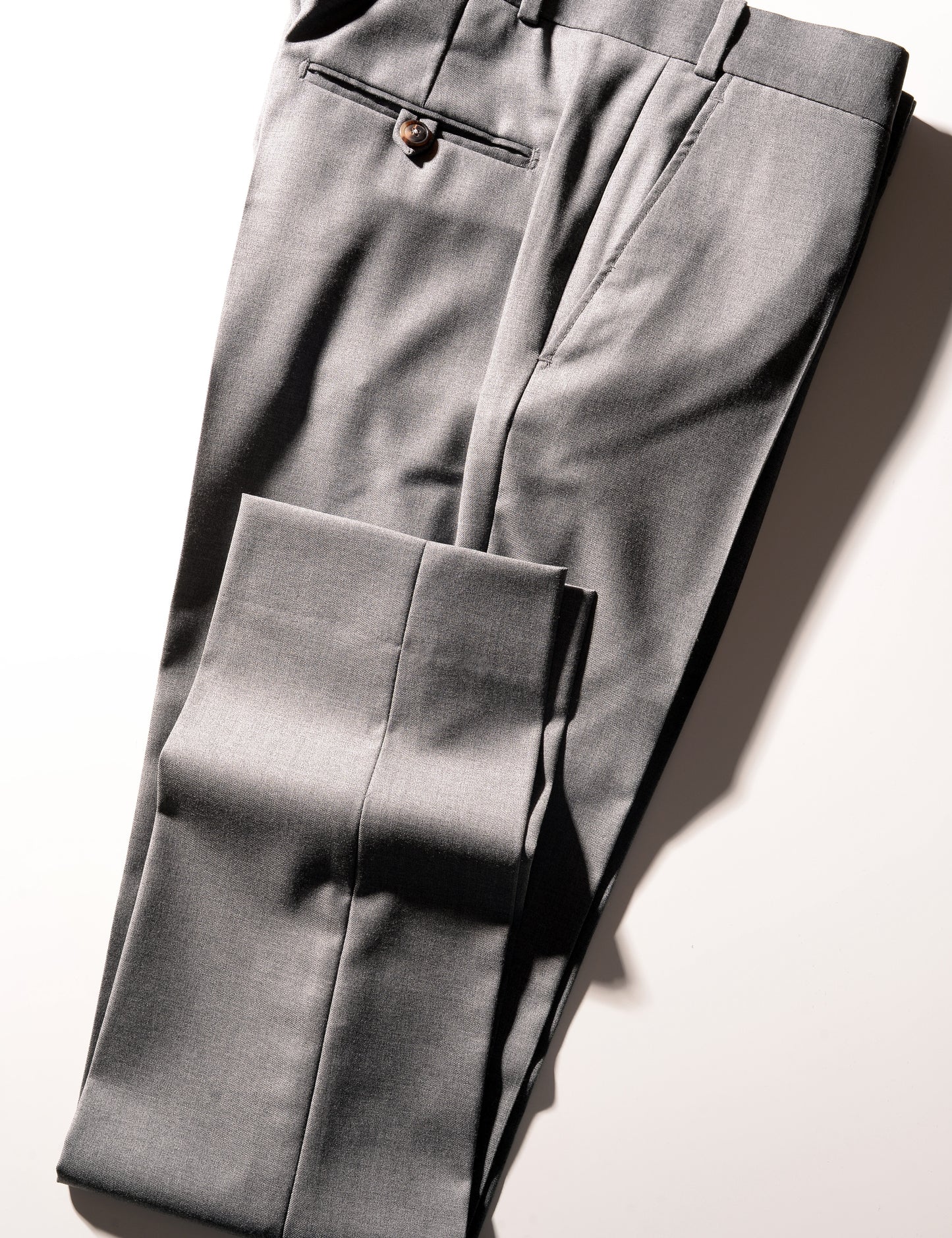 Detail shot of Brooklyn Tailors BKT50 Tailored Trouser in Super 110s Twill - Dove Gray showing hem, side pocket, back pocket, and waistband
