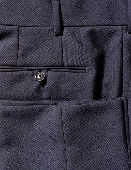 Detail photo of the trouser, showing fabric color and texture, and also the buttons and back pocket details.