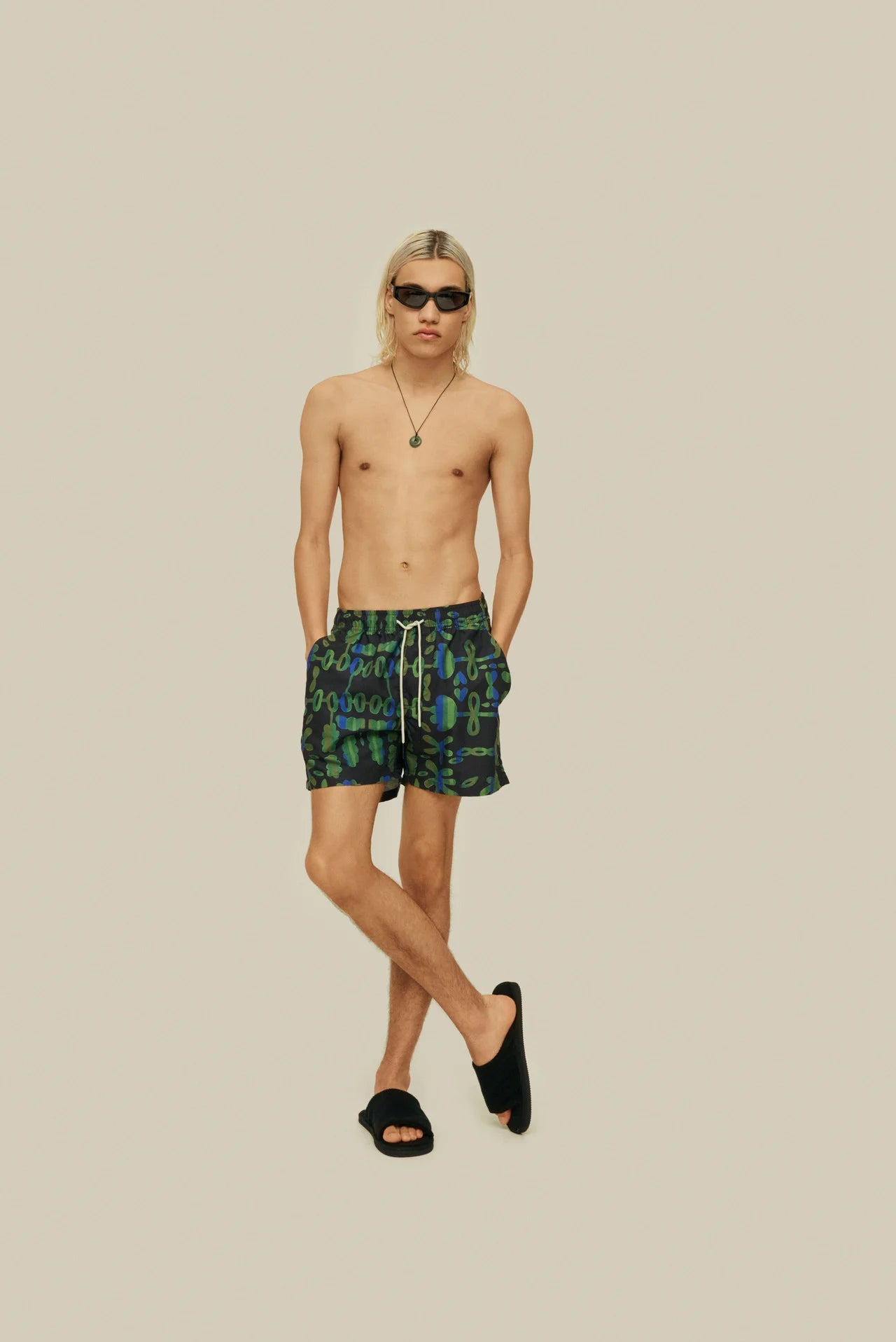 On-body front shot of OAS Feral Galbanum Swim Shorts