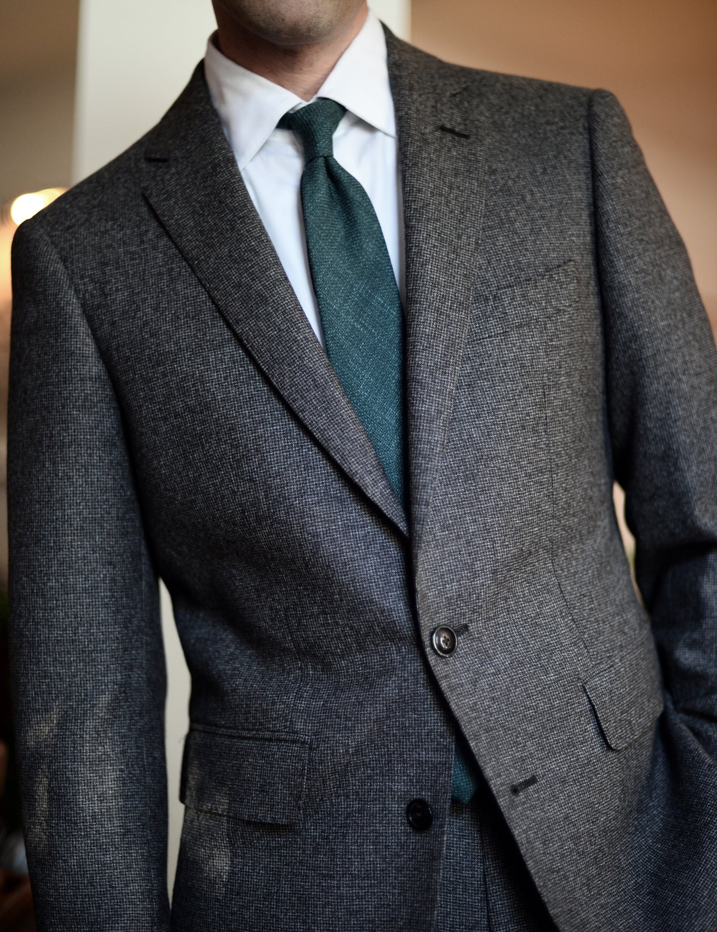 Silk, Wool, and Linen Hopsack Tie - Emerald on body. Model is wearing a suit jacket and white dress shirt.