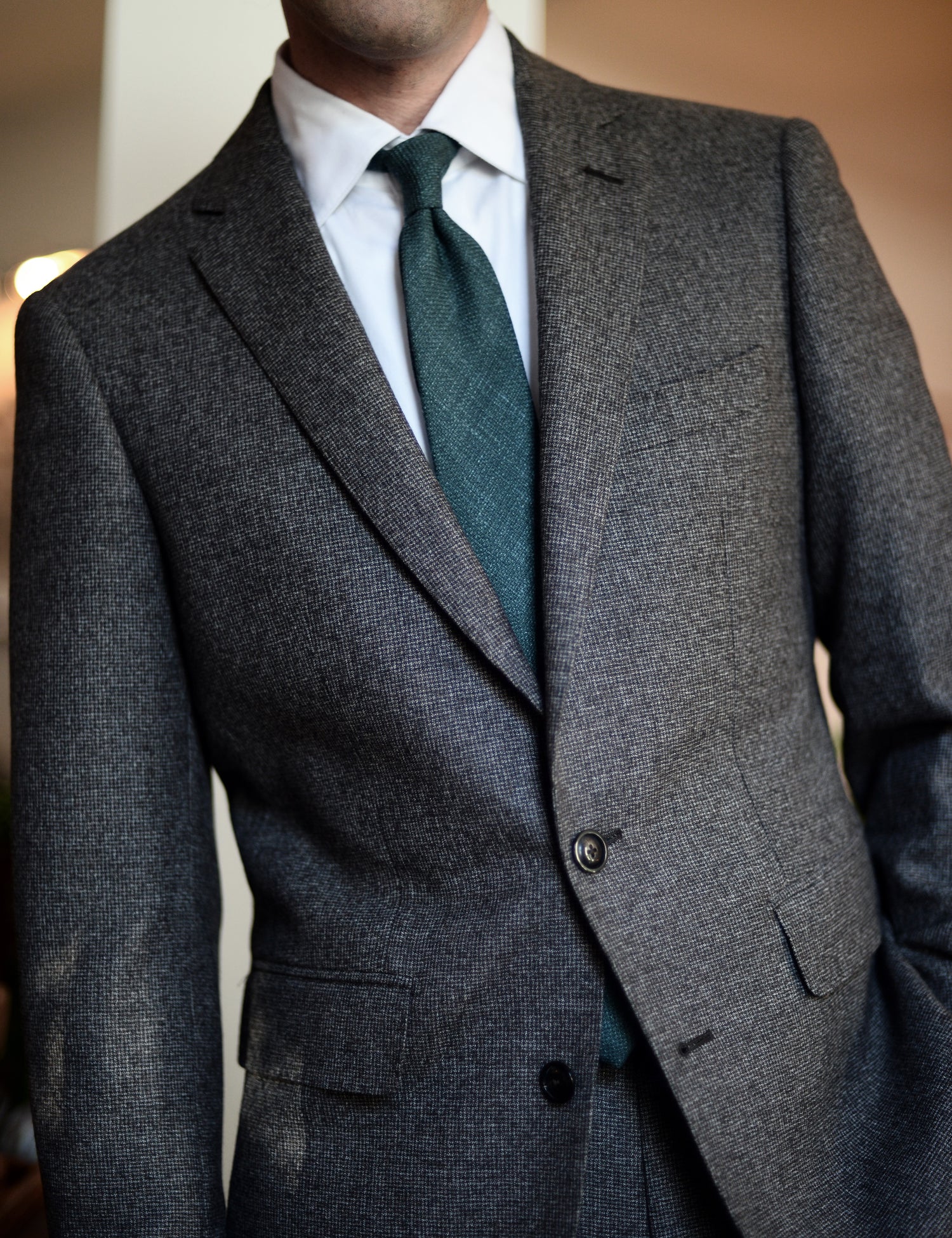 Silk, Wool, and Linen Hopsack Tie - Emerald on body. Model is wearing a suit jacket and white dress shirt. 