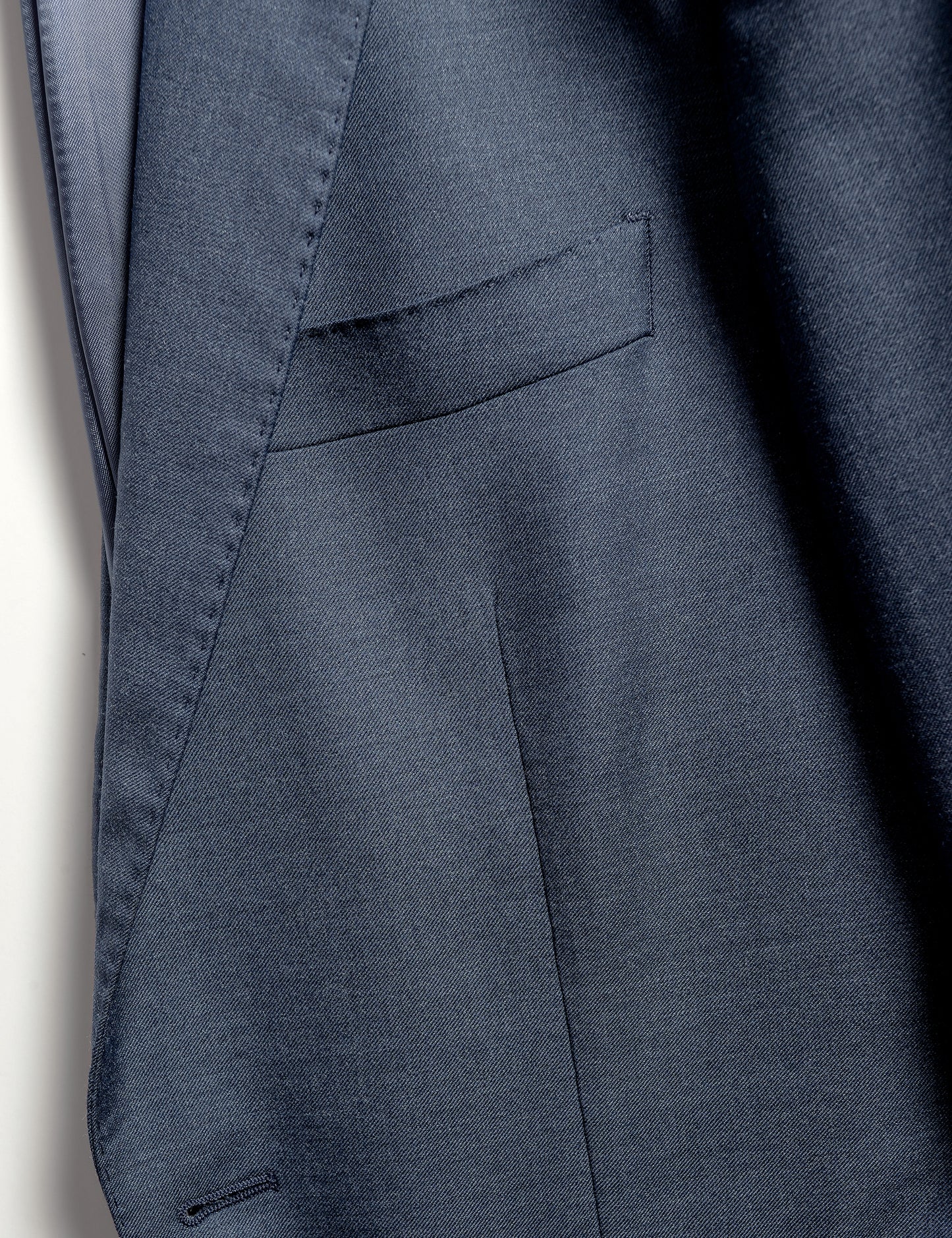 Close up on BKT50 Tailored Jacket in Super 130s Heather Twill - Cool Blue showing fabric detail, lapel and chest pocket