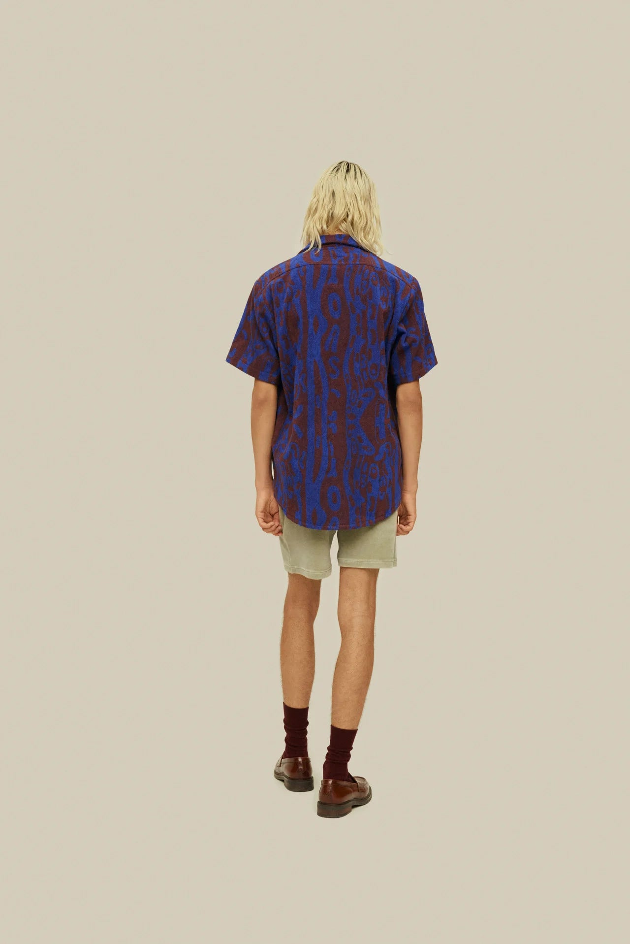 OAS Thenards Jiggle Cuba Terry Shirt on model. Model wears shirt with khaki shorts. Photo taken of back