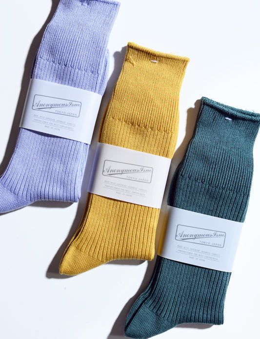 Shot of three colors of Anonymous Ism ribbed crew socks