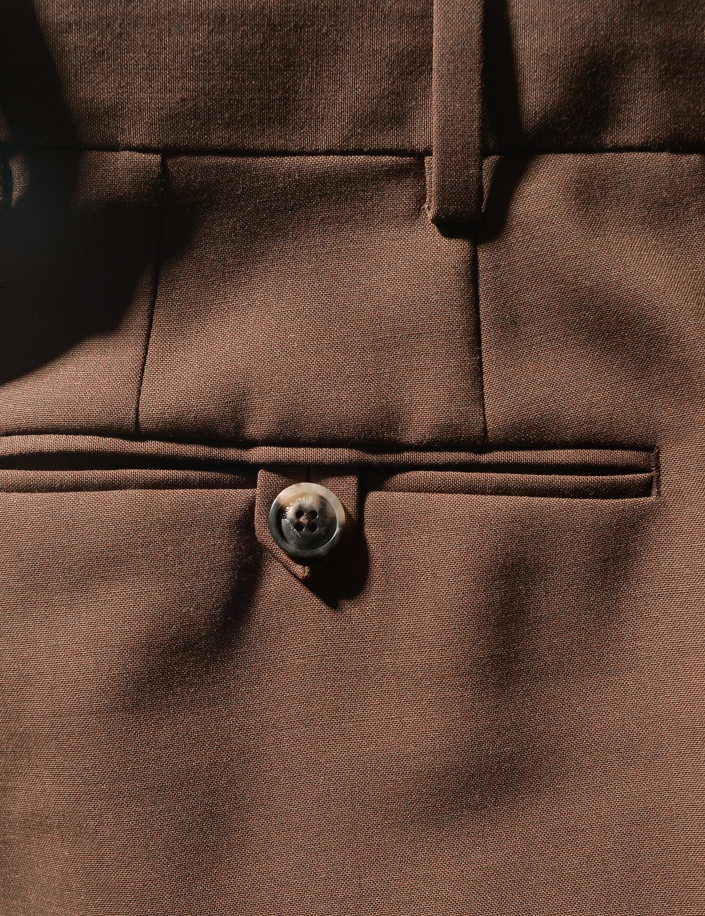 Detail shot of Brooklyn Tailors BKT50 Tailored Trousers in Heathered Plainweave - Tawny Brown showing back pocket and fabric texture