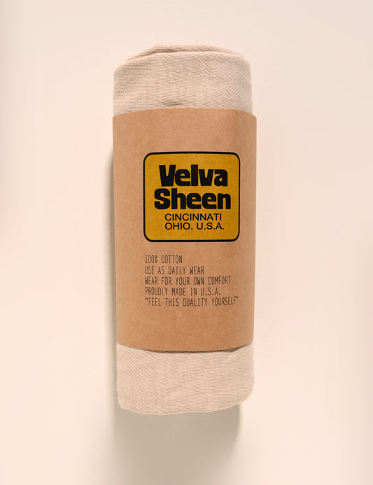 Image of Velva Sheen Crewneck T-Shirt in Oat Milk rolled in a paper sleeve