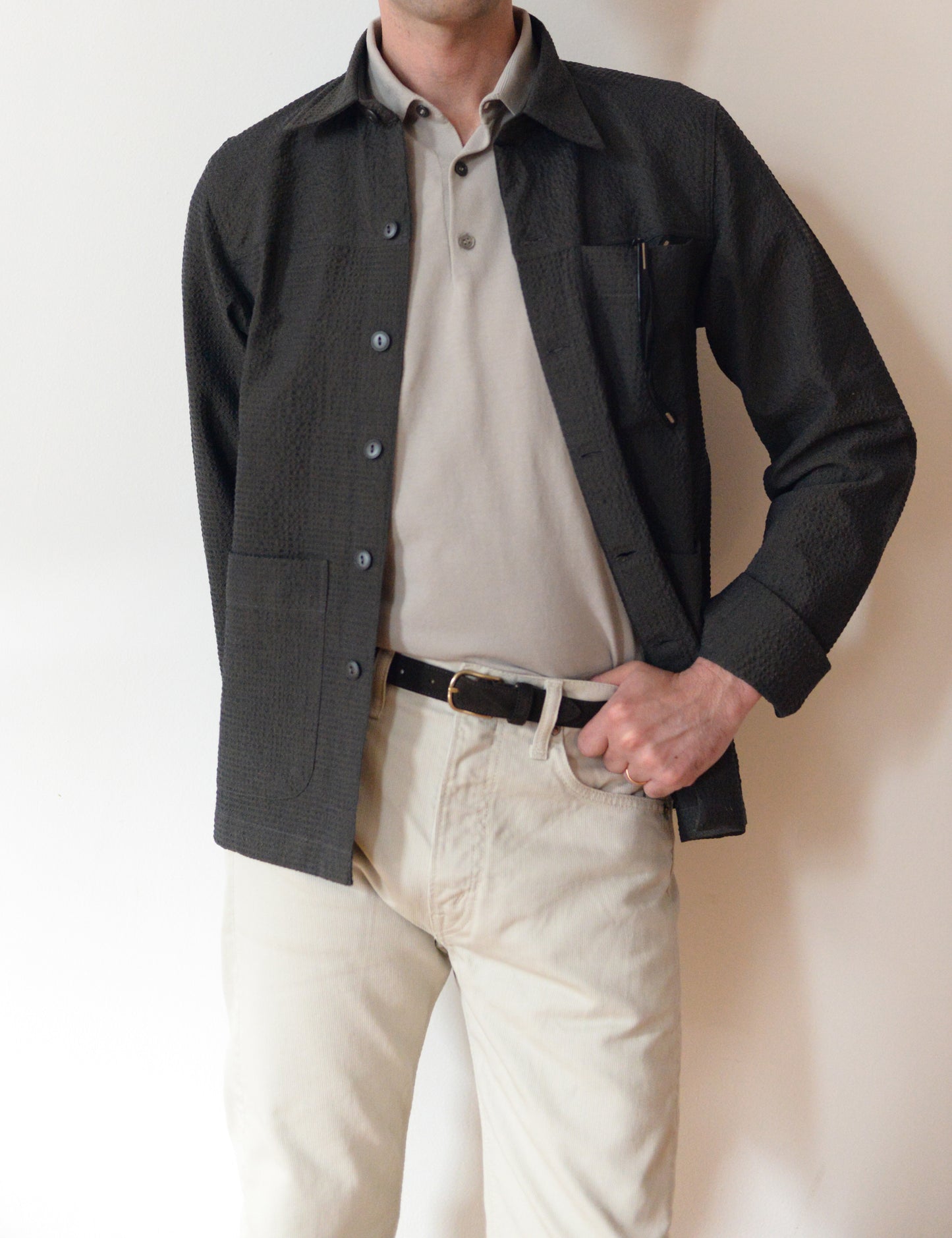 Brooklyn Tailors BKT15 Shirt Jacket in Crinkled Wool & Cotton - Storm on-body shot. Model is wearing gray polo shirt, cream corduroys, a dark brown belt with the shirt jacket.