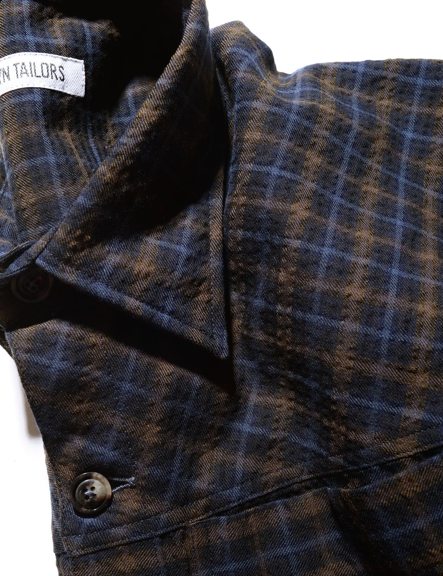 Detail of BKT15 Shirt Jacket in Crinkled Wool & Cotton - Autumn Check showing collar, button, and fabric pattern and texture