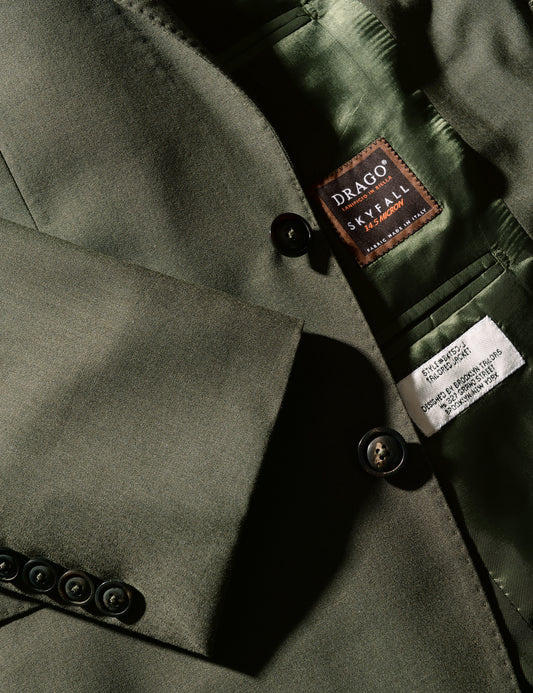 Detail of Brooklyn Tailors BKT50 Tailored Jacket in 14.5 Micron Mouliné - Agave Green showing Drago label, buttons, and cuff