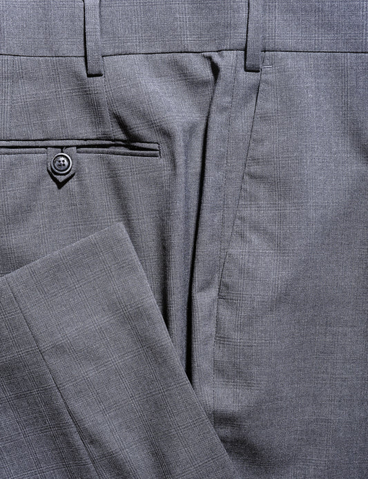 Detail of BKT50 Tailored Trousers in Tropical Wool - Gray Plaid showing hem, back pocket, and fabric pattern