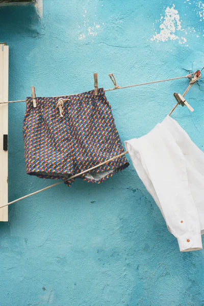 detail of Ripa Ripa Swim Shorts in Meandro Vivido on a clothes line