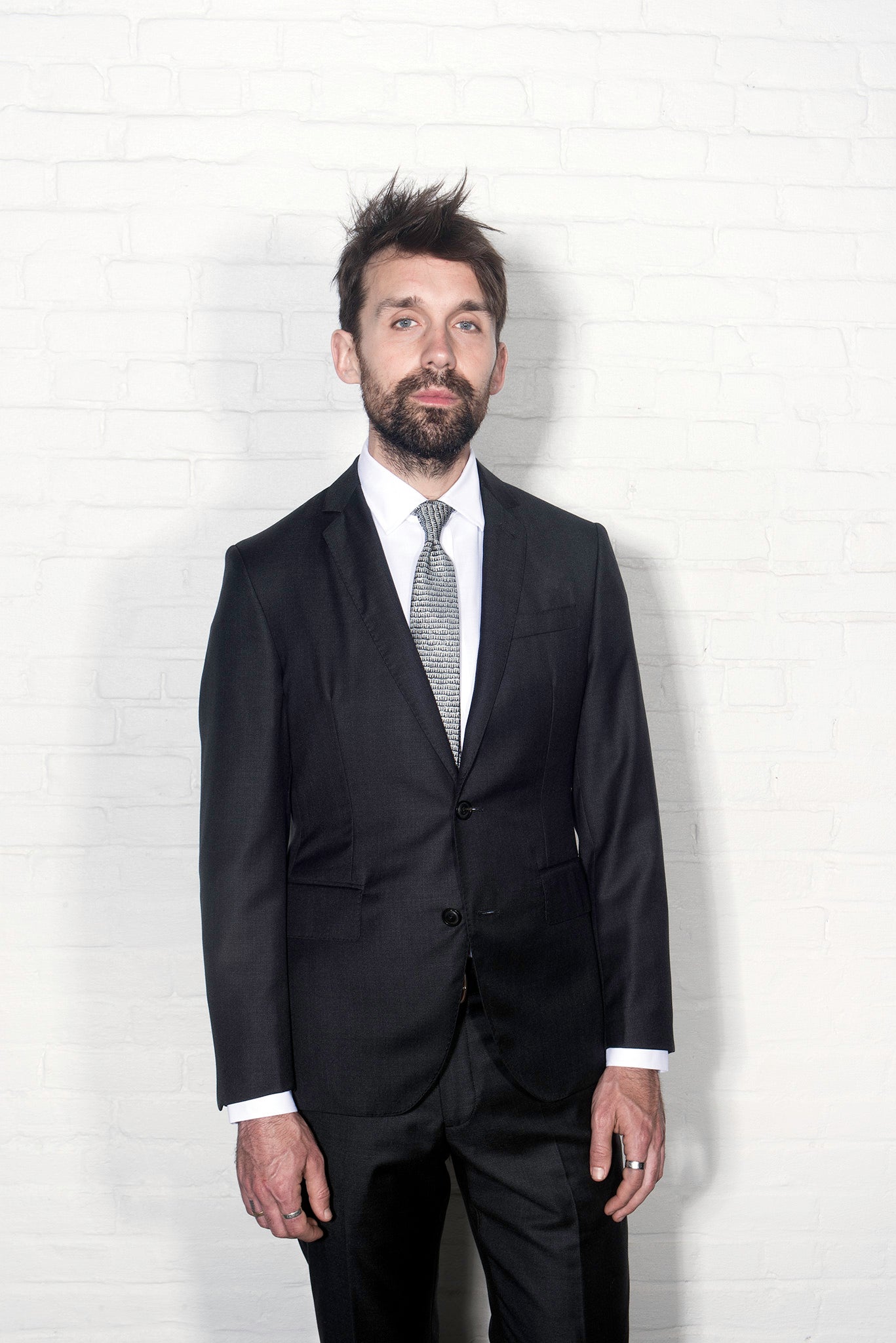 Brooklyn Tailors BKT50 Tailored Jacket in Super 110s Twill - Charcoal on-body shot. Model is wearing the jacket with matching pants, a white dress shirt and tie.