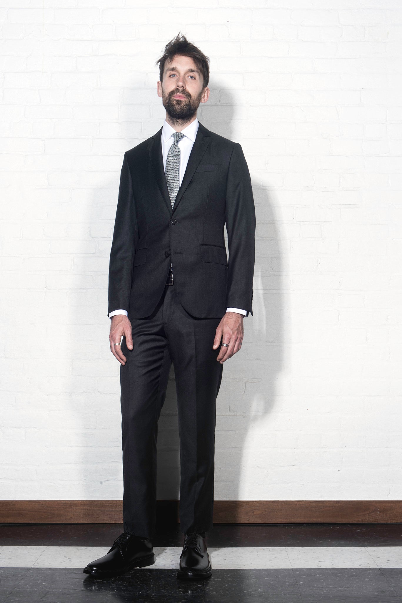 Brooklyn Tailors BKT50 Tailored Jacket in Super 110s Twill - Charcoal on-body shot. Model is wearing the jacket with matching pants, a white dress shirt and tie.