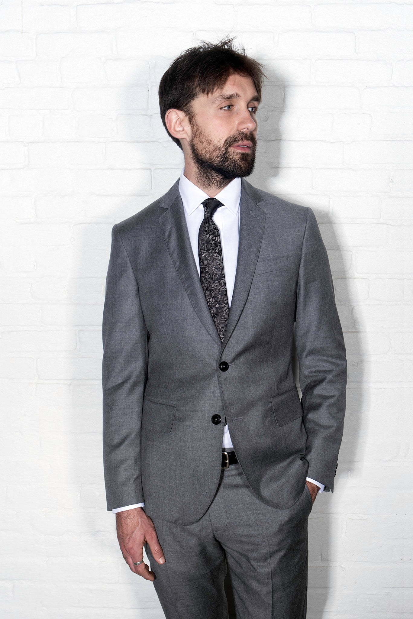 Brooklyn Tailors BKT50 Tailored Jacket in Super 110s Twill - Dove Gray on-body shot. Model is wearing jacket with matching pants, white dress shirt, tie, and black belt. 