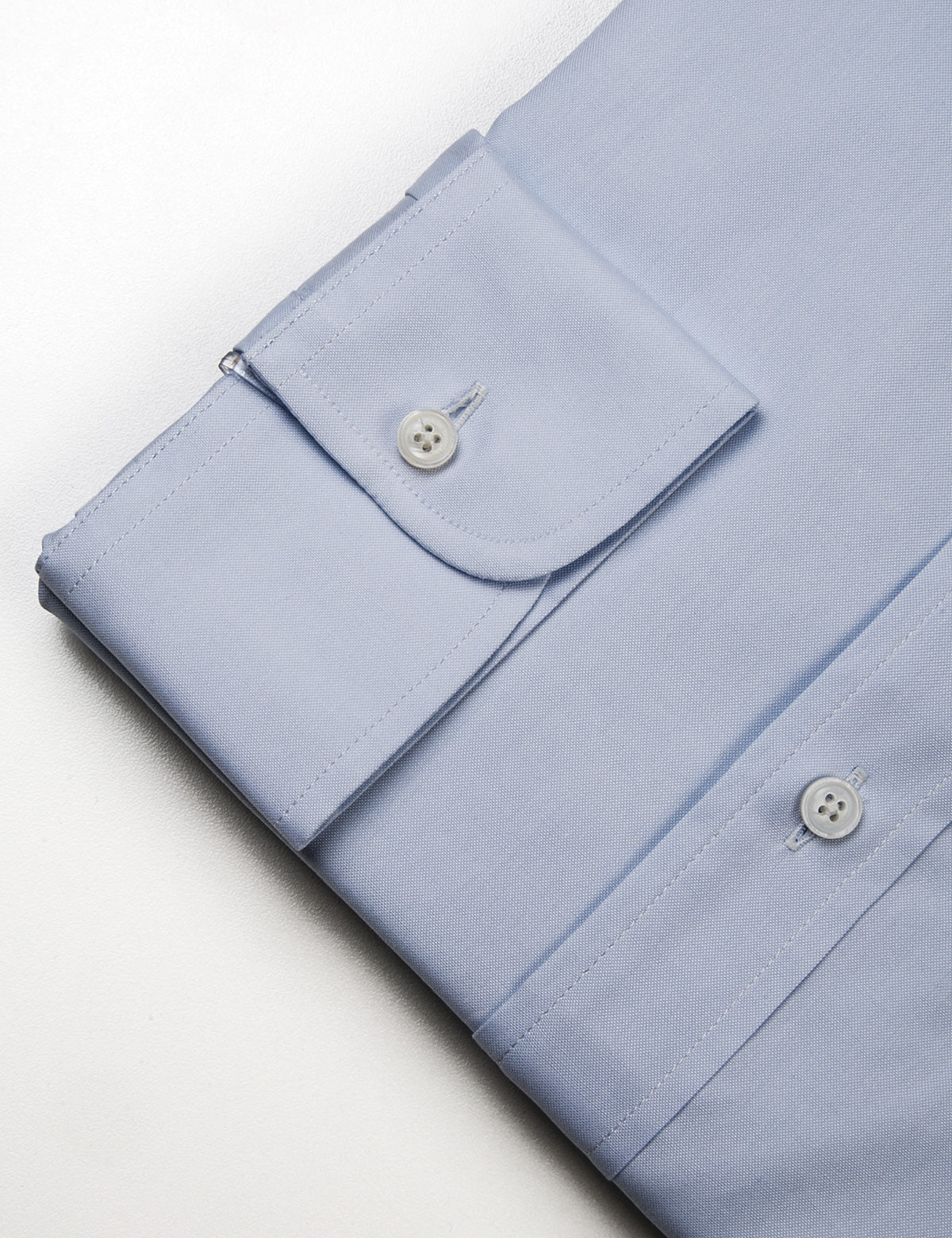 Detail shot of collar, buttons, and fabric texture on Brooklyn Tailors BKT20 Slim Dress Shirt in Pinpoint Oxford - Light Blue