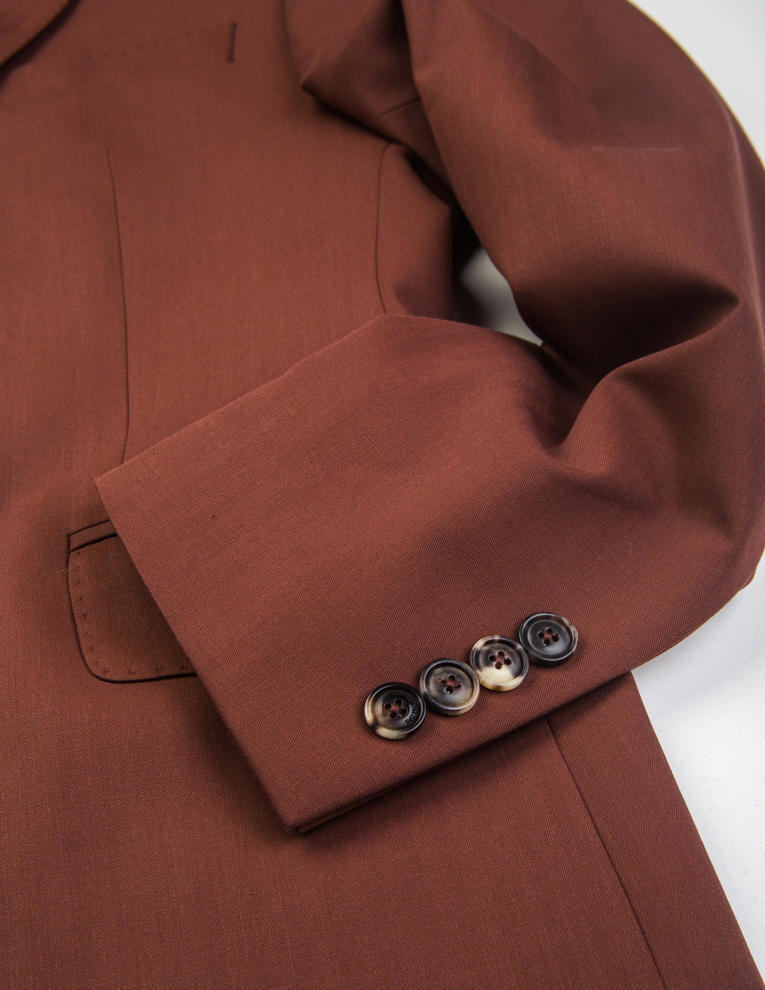 Detail shot of Brooklyn Tailors BKT50 Tailored Jacket in Herringbone Wool/Cotton - Brick showing sleeve and buttons