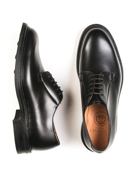 Flat shot of Joseph Cheaney Deal II Derby in Black Calf Leather. One shoe is on its side to show profile