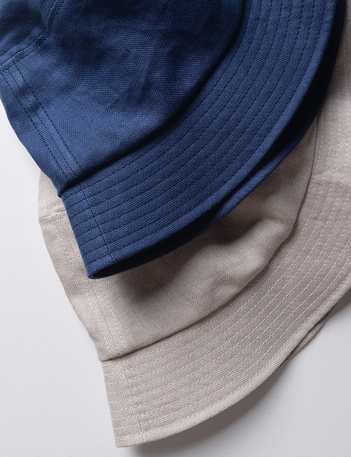 Detail shot of two colors of French Linen Bucket Hat  to show fabric weave