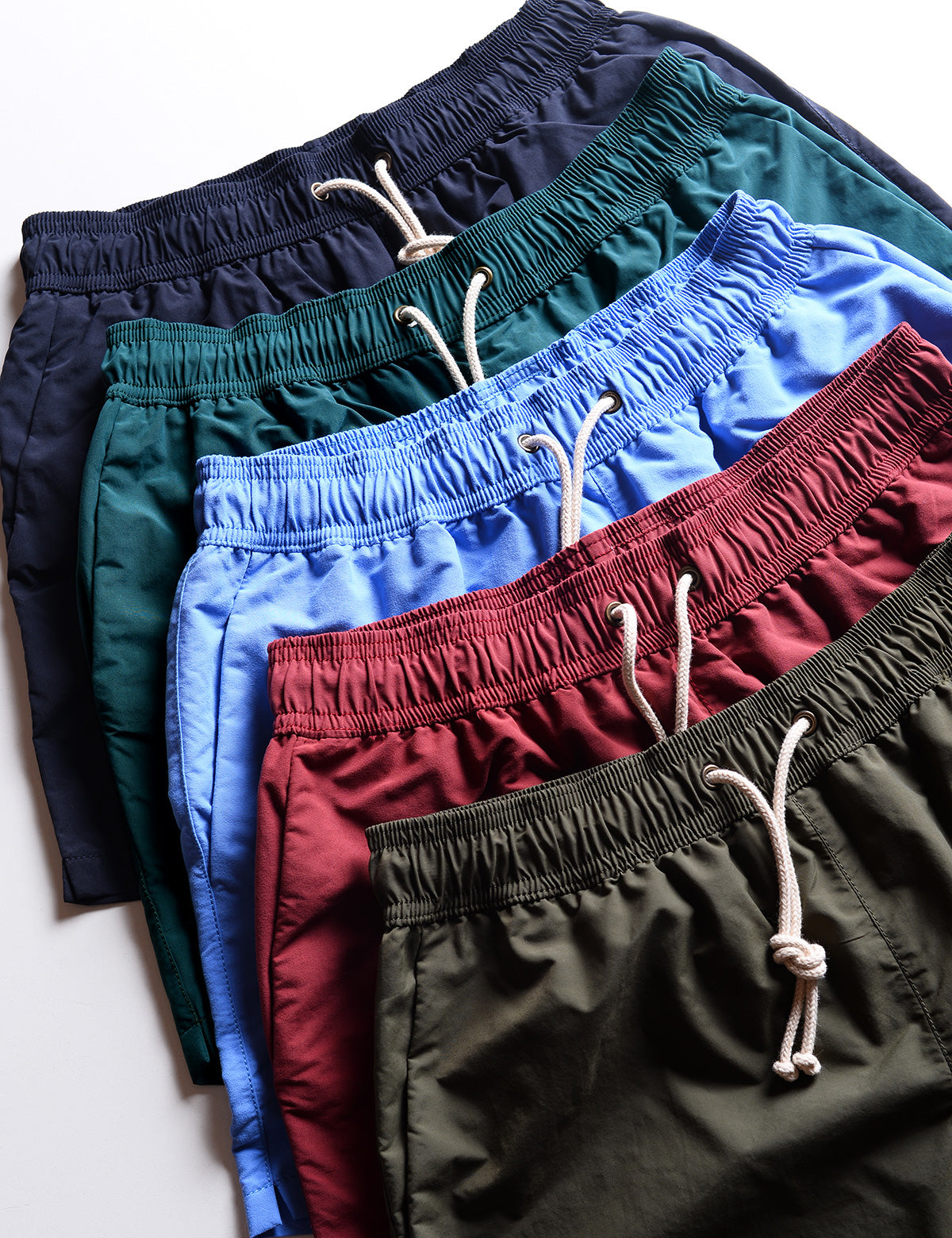 Detail of several colors of Ripa Ripa swim shorts