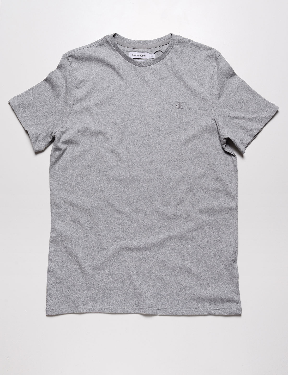 Full length flat shot of Calvin Klein Short Sleeve Smooth Cotton Solid Crewneck Tee - Heroic Heather Gray