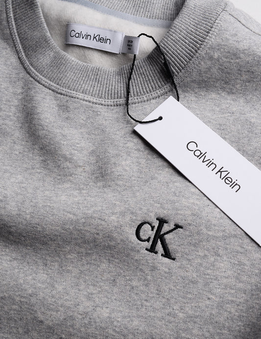Detail of Calvin Klein Archive Logo Fleece Crewneck - Heroic Heather Gray showing logo, neck, and tag