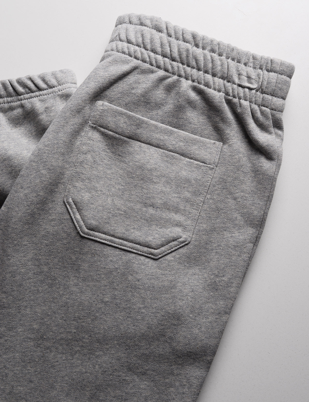 Folded detail of Calvin Klein Archive Logo Fleece Jogger - Heroic Heather Gray showing back pocket and wasitband