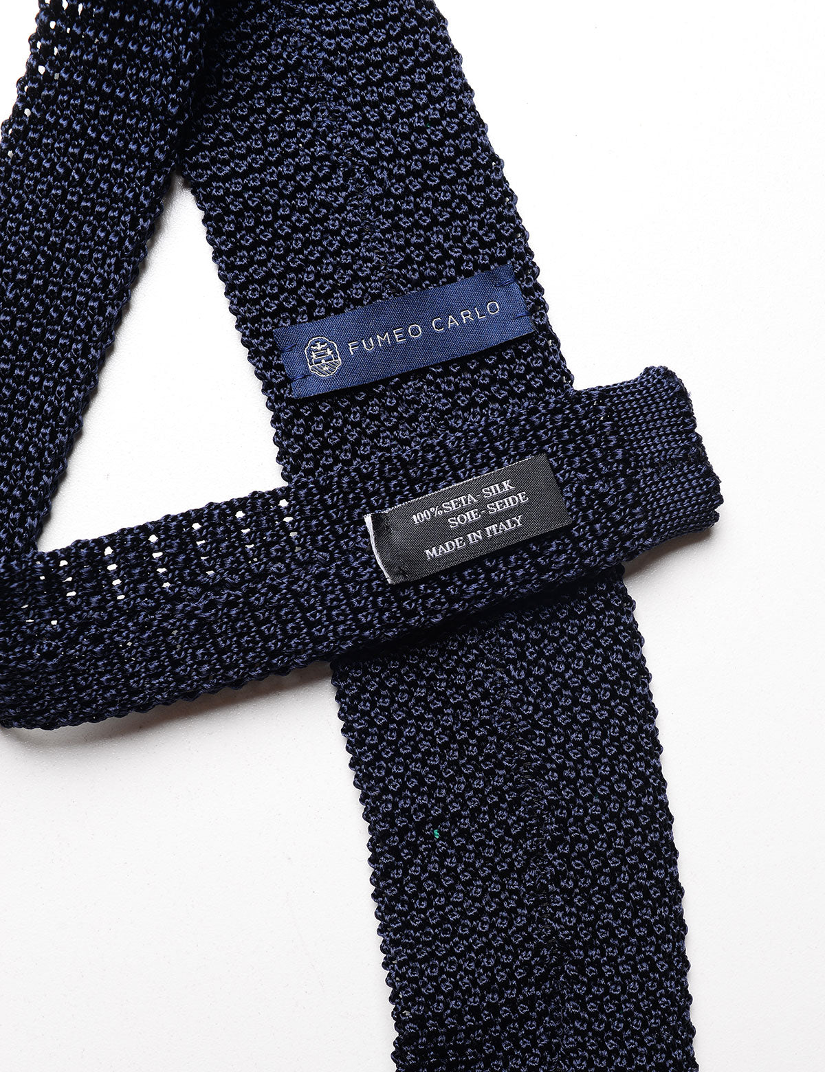 Detail shot of Fumeo Carlo Dot Pattern Silk Knit Tie - Navy & Green showing labeling