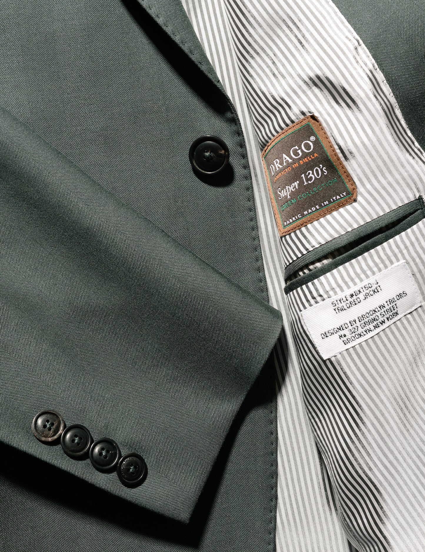 Detail of BKT50 Tailored Jacket in Wool Herringbone - Cyprus showing cuff, lining, and labels