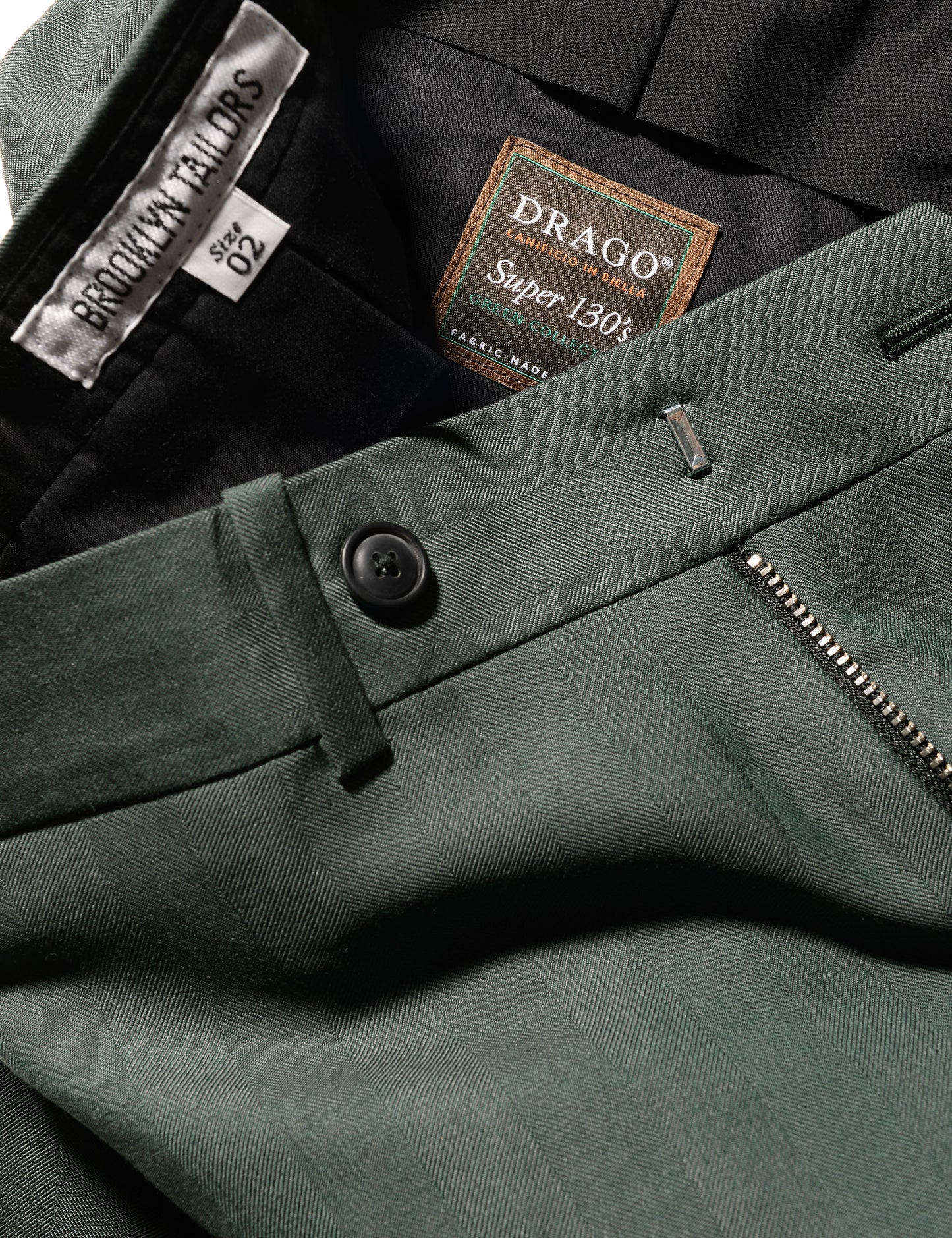 Detail of BKT50 Tailored Trousers in Wool Herringbone - Cyprus showing fabric pattern, waist, and interior labels