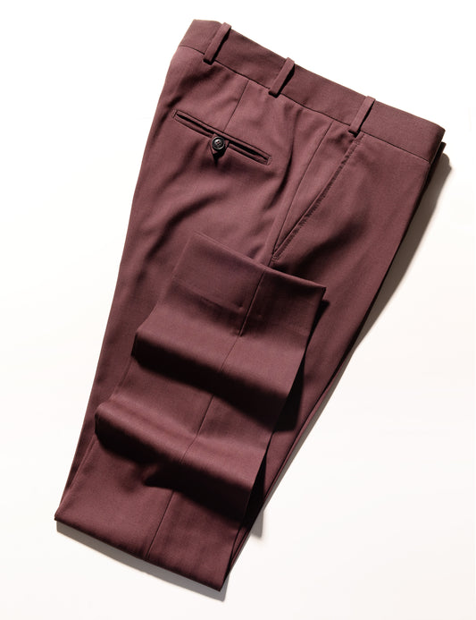 Folded shot showing BKT50 Tailored Trousers in Wool Herringbone - Syrah hem, back pocket, and fabric weave