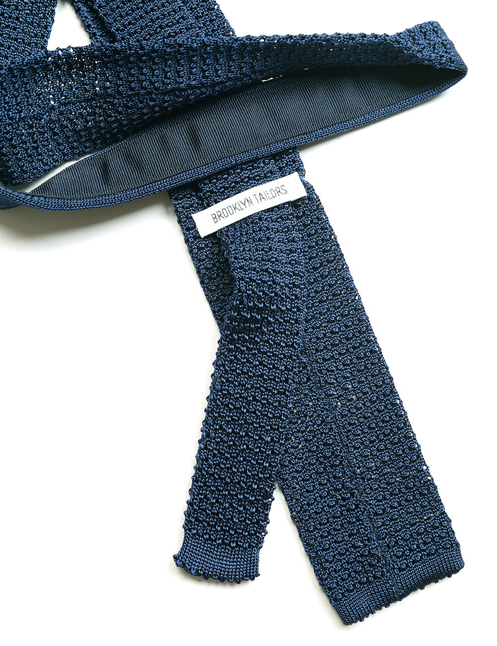 Detail of Italian Silk Knit Tie - Aegean Blue showing label and fabric texture