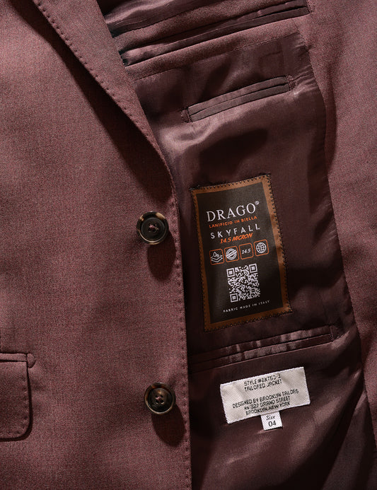 Detail shot of Brooklyn Tailors BKT50 Tailored Jacket in 14.5 Micron Mouliné - Cordovan showing Drago label, buttons, lapel, and pocket