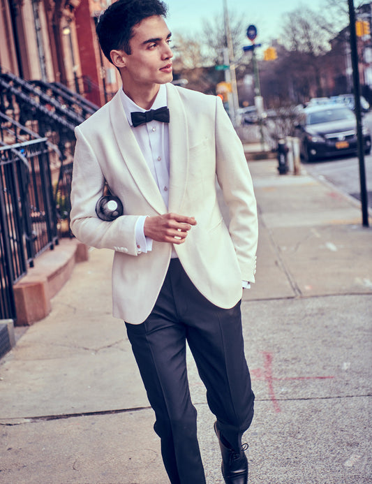 Brooklyn Tailors BKT50 Shawl Collar Dinner Jacket in Silk & Wool Textured Weave - Ivory on-body shot. Model is wearing jacket with a white tuxedo shirt, mother-of-pearl dress studs and cufflinks, a black trouser, black dress shoes, and a black bowtie