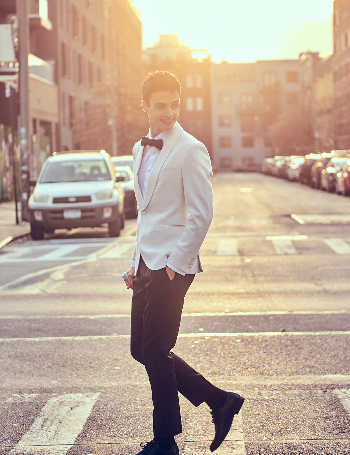 Brooklyn Tailors BKT50 Shawl Collar Dinner Jacket in Silk & Wool Textured Weave - Ivory on-body shot. Model is wearing jacket with black trousers, a white tuxedo shirt, black bowtie, and black dress shoes
