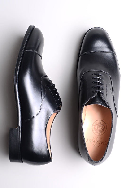 Photo of both Joseph Cheaney Alfred Capped Oxford in Black Calf Leather shoes with one on its side
