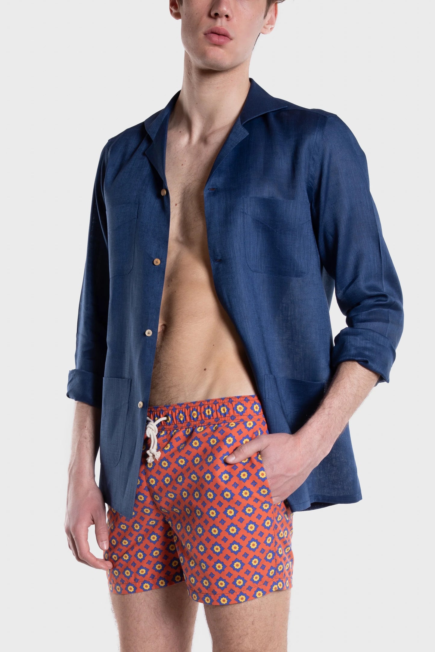 Model wears Ripa Ripa Ischia Linen Shirt - Blu Notte with swim trunks