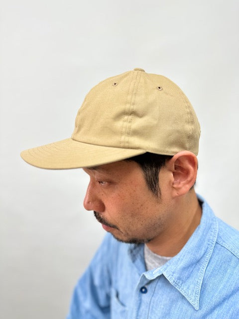 On-body side view of Cableami Loose Light Chino Baseball Cap  showing how the style fits.