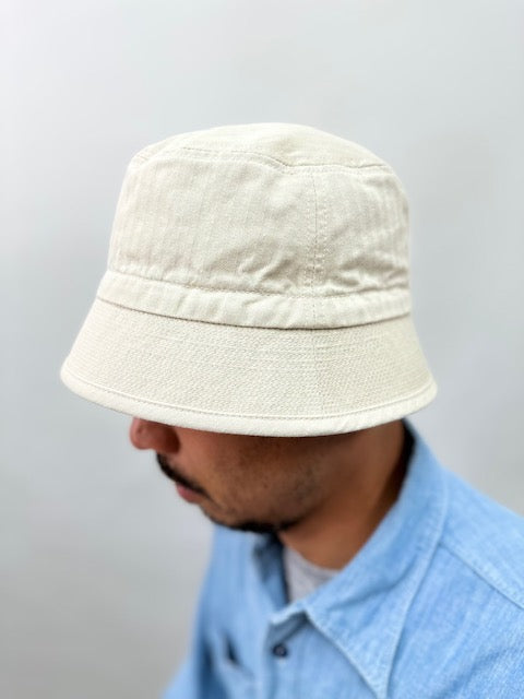 On-body image of Cableami Organic Cotton Herringbone Bucket Hat style (not in the olive green color) to show how the style fits