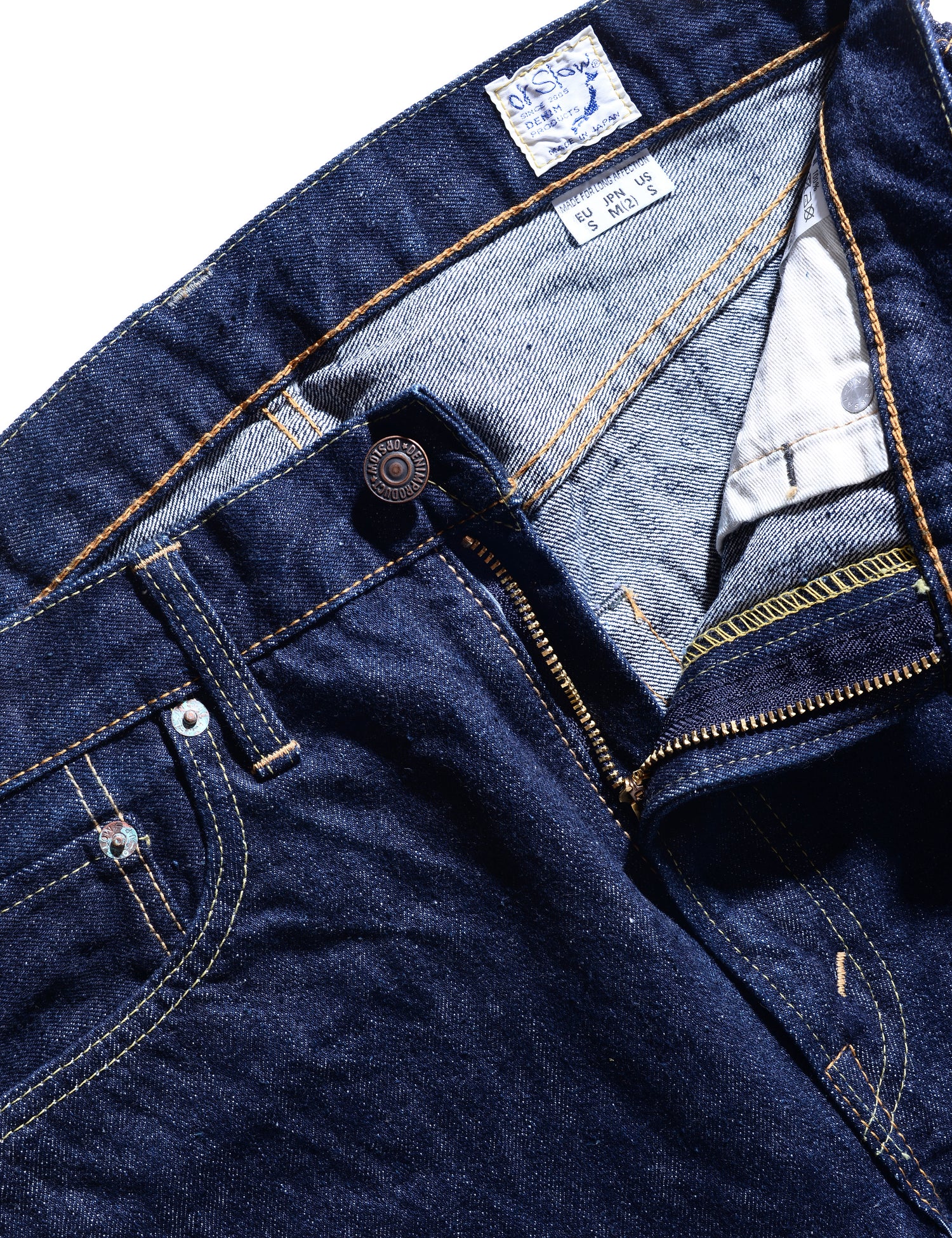 Unzipped detail shot showing zipper, button, pocket, and labeling of 107 Slim Fit Selvedge Denim Jeans - One Wash