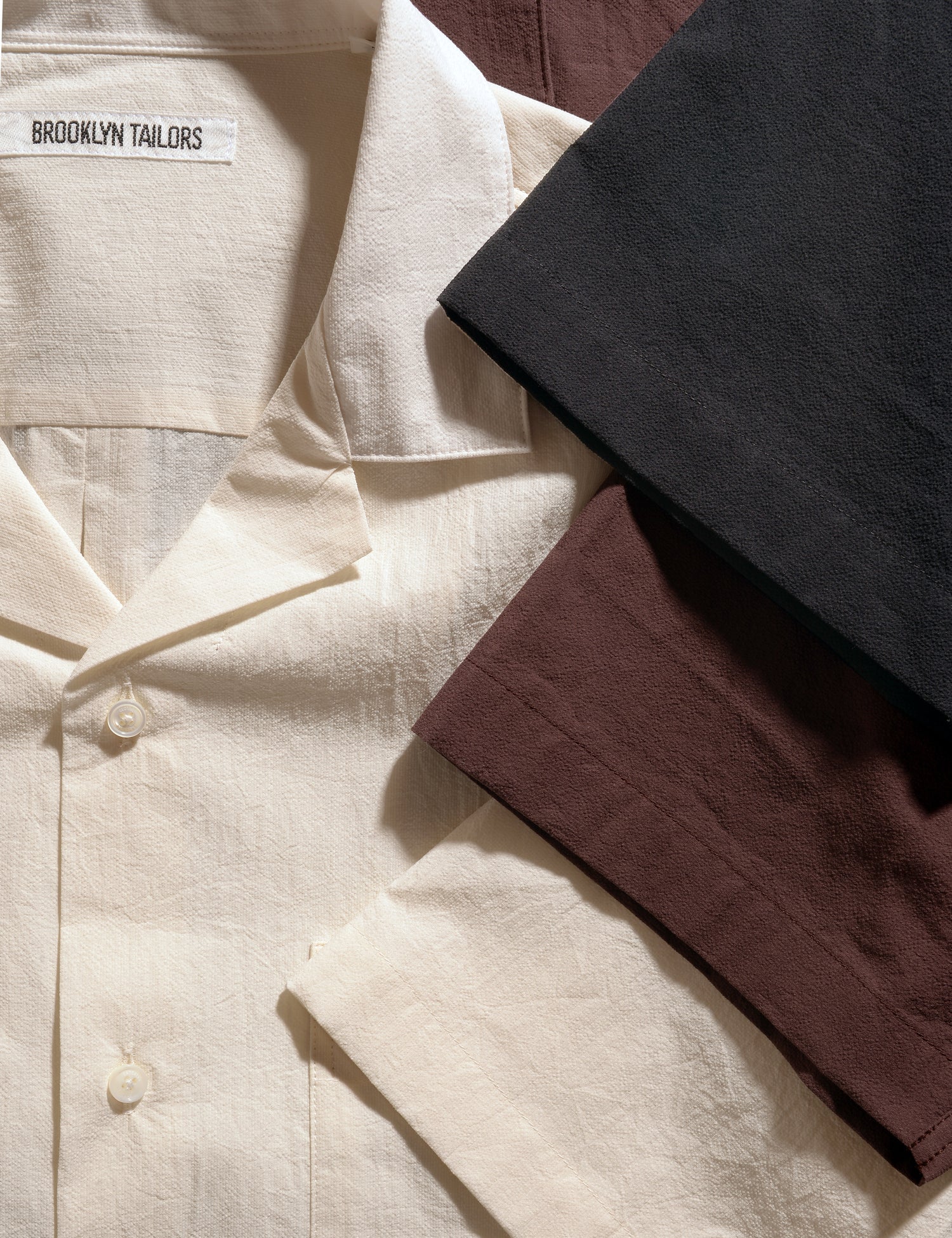 Close-up shot of three colors of Brooklyn Tailors BKT18 Camp Shirts in Crinkled Cotton showing sleeves, collar, and fabric texture