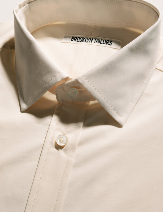 Detail shot of Brooklyn Tailors BKT20 Slim Dress Shirt in Supima Cotton Twill - Ivory showing collar, buttons, and placket