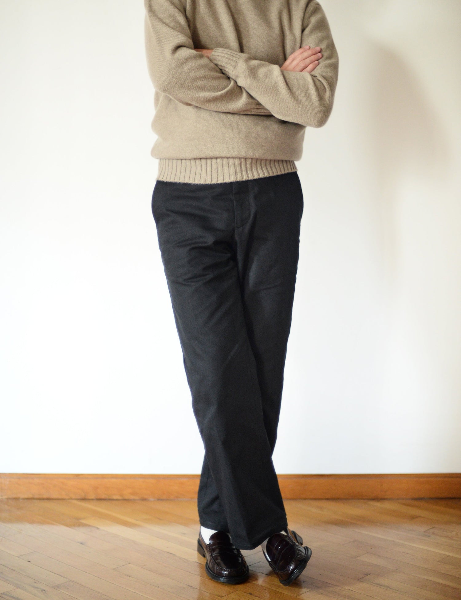 Brooklyn Tailors BKT36 Straight Leg Pant in Cotton Cavalry Twill - Black on-body shot. Model is wearing the pants with a tan sweater, black loafers, and white socks