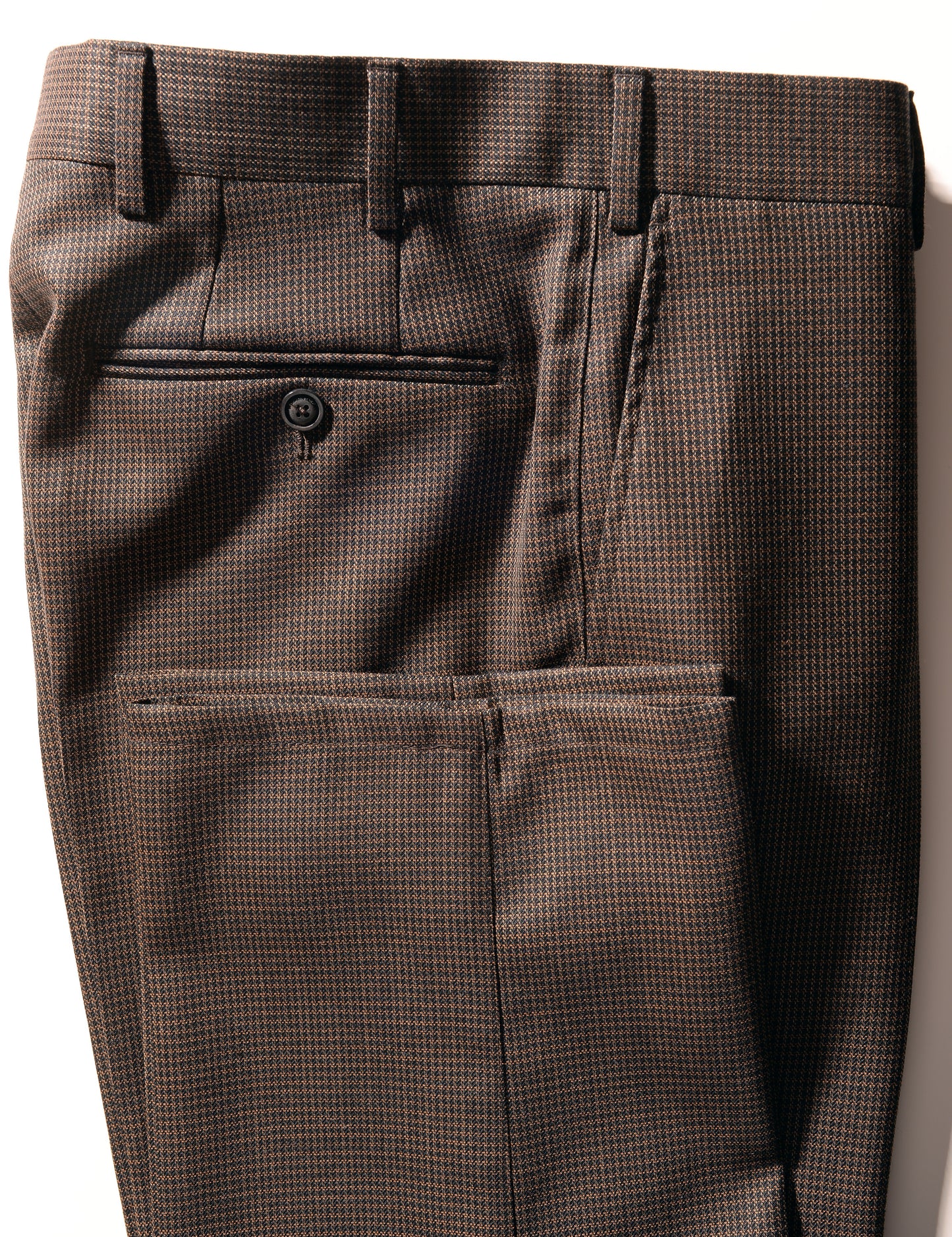 Folded side detail shot of Brooklyn Tailors BKT36 Straight Leg Trouser in Wool Grid Weave - Blackened Earth showing hem, back pocket, side pocket, and waistband